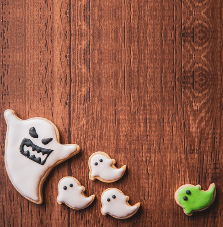 Fresh delicious homemade decorated halloween cookies sweets on dark wooden background, concept of halloween party, copy space(text space), top view, blank for text.の写真素材