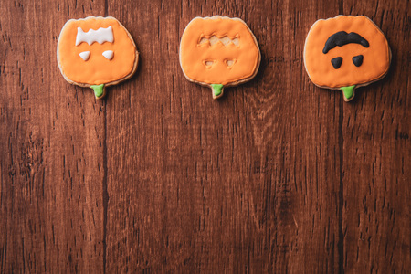 Fresh delicious homemade decorated halloween cookies sweets on dark wooden background, concept of halloween party, copy space(text space), top view, blank for text.の写真素材