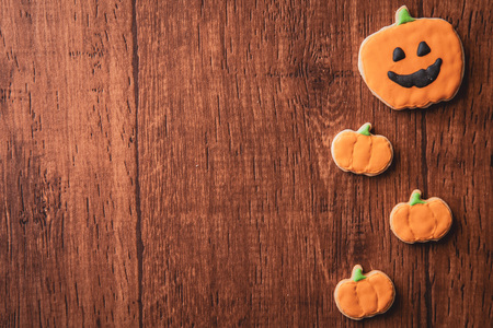 Fresh delicious homemade decorated halloween cookies sweets on dark wooden background, concept of...