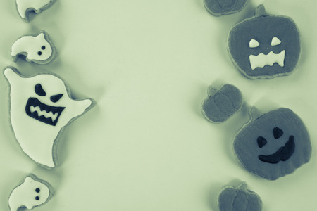 Fresh delicious homemade decorated halloween cookies sweets on dark wooden background, concept of halloween party, copy space(text space), top view, blank for text.の写真素材