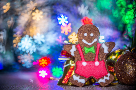 Cute gingerbread man with christmas tree and blurry sparkle background, close up, bokeh, text...