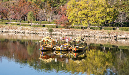 Osaka, Japan, November 25, 2018: Osaka castle ship (osaka jyo gozabune) in grand and beautiful world famous Osaka castle river in autumn with blue sky, Japan, close upのeditorial素材