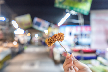 Fresh and delicious Taiwanese deep fried chicken (Salt crispy chicken) in Taiwan's night market, close up.の写真素材