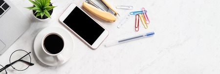 Stylized marble office working desk with smartphone, laptop, glasses and coffee, workspace design,...