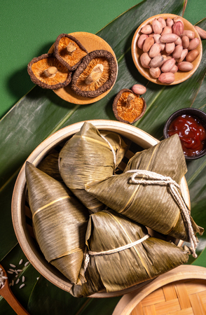 Close up, copy space, top view, flat lay. Famous asian chinese tasty handmade food in duan wu festival, steamed rice dumplings shaped like pyramidal ingredientsの写真素材
