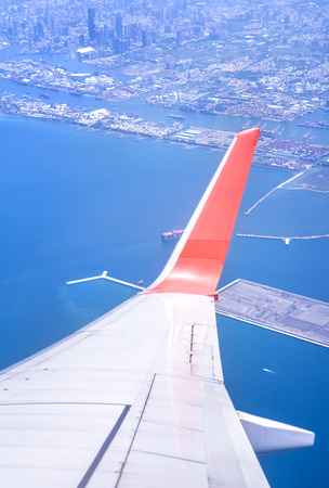 Bussiness and travel concept. Aerial view through window inside aircraft cabin with beautiful blue sky and cloud with sunlight, copy space, top viewの写真素材