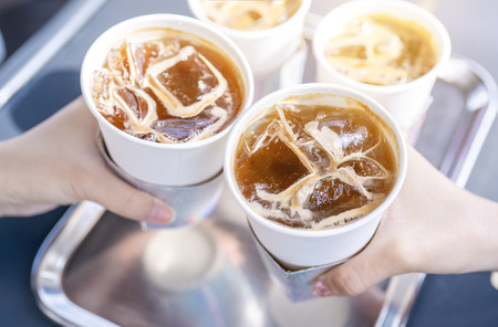 Party concept, girl with friends hold coffee cups and say cheers happy hangout together in cafe,...