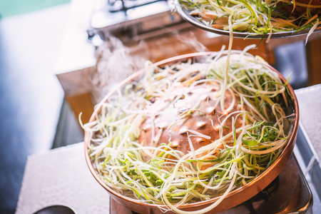 Beef barbecue bulgogi in South Korea restaurant in Seoul, lifestyle fresh korean food cuisine on copper pan with sliced grill, close up, copy spaceの写真素材