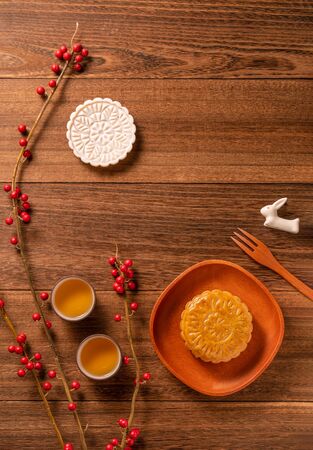 Chinese traditional mooncake with teacups on wooden background, Mid-Autumn Festival concept, top view, flat lay.の写真素材