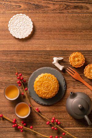 Chinese traditional mooncake with teacups on wooden background, Mid-Autumn Festival concept, top view, flat lay.の写真素材
