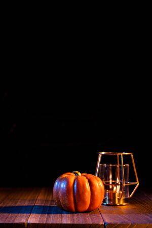 Halloween concept - Pumpkin on a dark wooden table with black background, trick or treatの写真素材