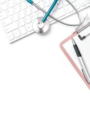 Doctor diagnoses concept - stethoscope on computer keyboard with medical record case and pen on white working table. Top view, flat lay, copy spaceの写真素材