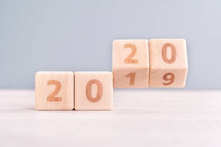 New year countdown concept - wood blocks on wooden table and blue background, close up, copy space.の写真素材