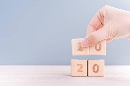 Abstract 2020 & 2019 New year countdown design concept - woman holding wood blocks cubes on wooden...