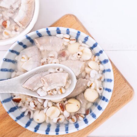 Tasty Four Tonics Herb Flavor Soup, Taiwanese traditional food with herbs, pork intestines on white wooden table, close up, flat lay, top viewの写真素材