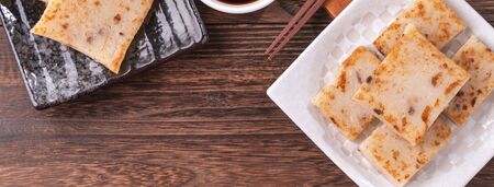 Delicious turnip cake, Chinese traditional local radish cake in restaurant with soy sauce and...