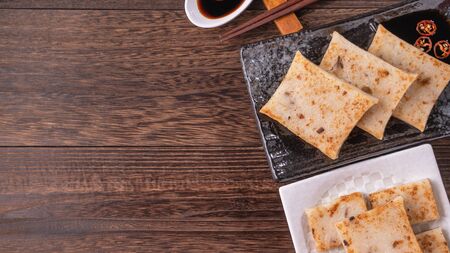 Delicious turnip cake, Chinese traditional radish cake in restaurant with soy sauce for new year's dishes, close up, copy space, top view, flat lay.の写真素材