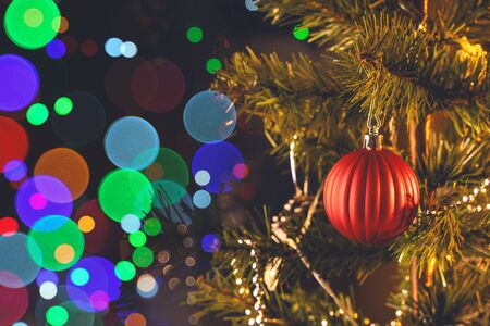 Beautiful Christmas decor concept, bauble hanging on the Christmas tree with sparkling light spot,...