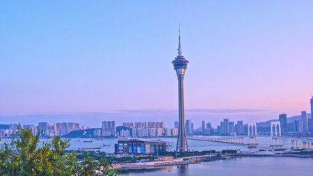 Macao, China - October 15, 2019: Macau (Macao) city skyline during sunset dusk time with Macau tower landmark and Ponte de Sai Van Bridge, design concept of busy business city.のeditorial素材
