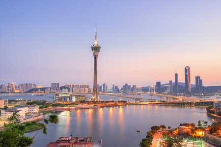 Macao, China - October 15, 2019: Macau (Macao) city skyline during sunset dusk time with Macau tower landmark and Ponte de Sai Van Bridge, design concept of busy business city.のeditorial素材