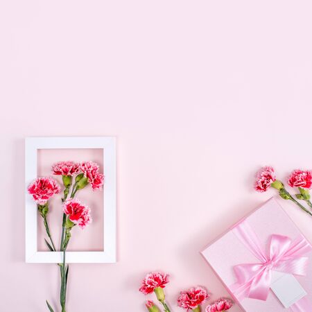 Mother's Day, Valentine's Day background design concept, beautiful pink, red carnation flower bouquet on pink table, top view, flat lay, copy space.の写真素材