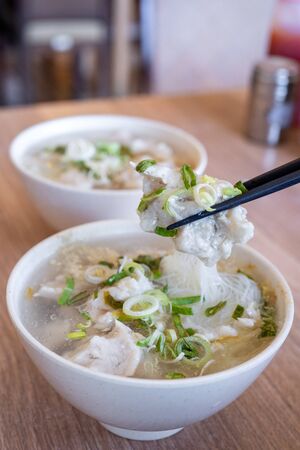 Delicious fish ball rice noodles in thick soup, common food in Tainan, Taiwan, Asia, Asian Taiwanese street delicacy cuisine, close up, lifestyle.の写真素材