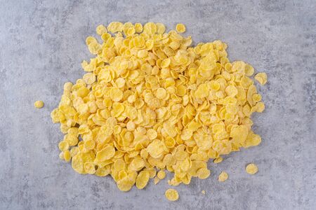Corn flakes bowl sweets on gray cement background, top view flat lay layout design, fresh and...