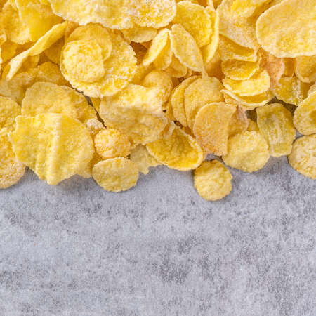 Corn flakes bowl sweets on gray cement background, top view flat lay layout design, fresh and...