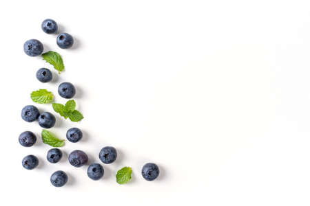 Blueberry fruit top view isolated on a white background, flat lay overhead layout with mint leaf,...