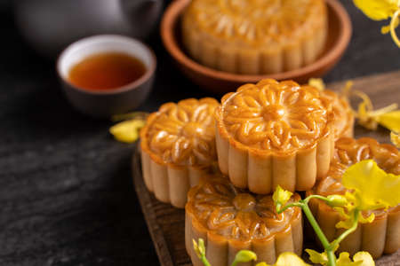 Mooncake, Moon cake for Mid-Autumn Festival, concept of traditional festive food on black slate...