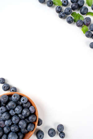 Blueberry fruit top view isolated on a white background, flat lay overhead layout with mint leaf, healthy design concept.の写真素材