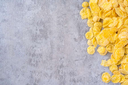 Corn flakes bowl sweets on gray cement background, top view flat lay layout design, fresh and healthy breakfast concept.の写真素材