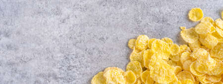 Corn flakes bowl sweets on gray cement background, top view flat lay layout design, fresh and healthy breakfast concept.の写真素材