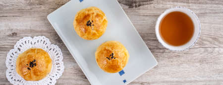 Moon cake yolk pastry, mooncake for Mid-Autumn Festival holiday, top view design concept on bright...