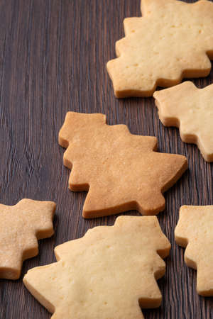 Close up of plain flavor gingerbread Christmas tree cookie on wooden table background. Food for...