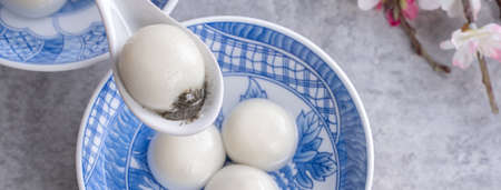 Top view of big tangyuan yuanxiao (glutinous rice dumpling balls) for lunar new year festival food, words on the golden coin means the Dynasty name it made.の写真素材