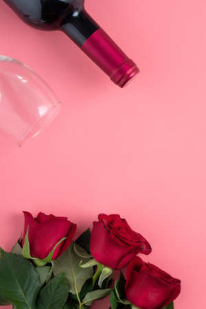 Valentine's Day dating gift with wine and rose concept on pink background design conceptの写真素材
