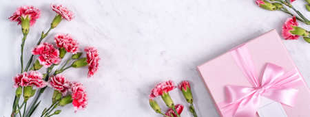 Top view of Mother's Day background design concept with carnation flower bouquet on marble tableの写真素材