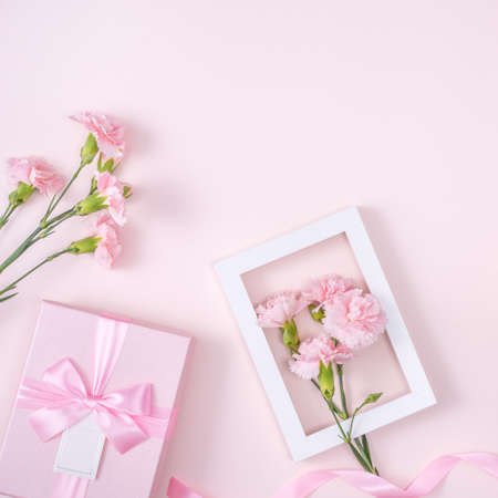 Mother's Day, Valentine's Day background design concept, beautiful pink carnation flower bouquet on pastel pink table, top view, flat lay, copy space.の写真素材