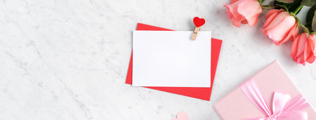 Valentine's Day design concept background with pink rose flower, gift box and card on marble white backgroundの写真素材