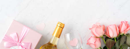 Giftbox and pink rose flower on marble white table background for Mother's Day holiday greeting design concept.の写真素材