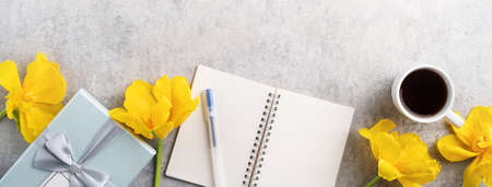 Concept of Mother's day holiday gift idea greeting design with yellow tulip flower bouquet on gray...