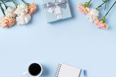 Design concpet of Mother's Day greeting with carnation flower, holiday gift idea and notebook diary...