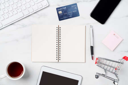 Top view of online shopping concept with credit card and electronics isolated on office marble white table background.の写真素材