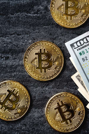 Business top view design concept of cryptocurrency bitcoin with USD Dollar paper currency money over...