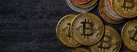 Top view business concept of bitcoin cryptocurrency money on dark black slate table background.