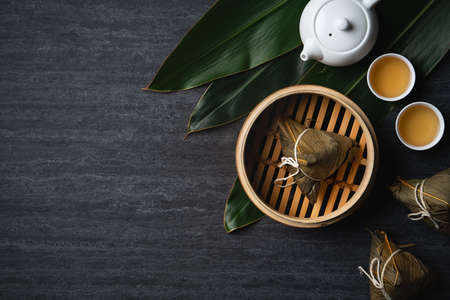 Zongzi rice dumpling top view for Chinese traditional Dragon Boat Festival (Duanwu Festival) over dark black slate background.の写真素材