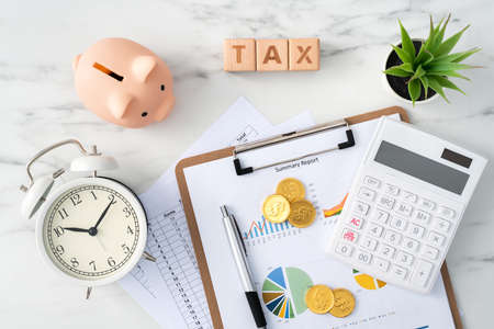 Top view of reading the overview and calculating, paying tax concept on marble white table.