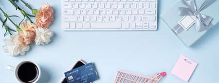 Mother's day buying gift design concept with carnation flower on office blue table desk background.の写真素材