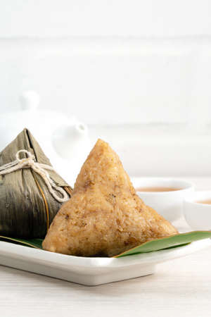 Zongzi. Rice dumpling for Chinese traditional Dragon Boat Festival (Duanwu Festival) on bright wooden table background.の写真素材